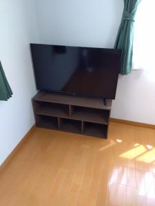 a flat screen tv sitting on a stand in a room at Restful Tsukuda - Vacation STAY 14829 in Aomori