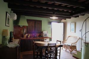 a kitchen with a table and chairs in a room at Apartaments Rurals Ai Manyac in San Miguel de Cruilles