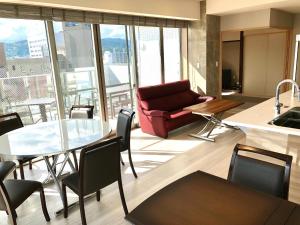 a living room with a couch and a table at Urban Grace Hiroshima 1301 - Vacation STAY 14847 in Hiroshima