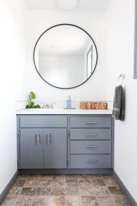 a bathroom with a blue vanity and a mirror at Northbank Loft in Springfield