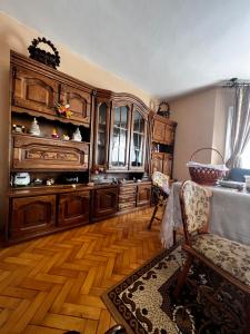 a living room with wooden floors and wooden cabinets at Casa Maramureșanului in Sighetu Marmaţiei