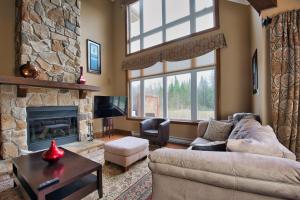 a living room with a couch and a fireplace at Rabaska by Rendez-Vous Mont-Tremblant in Mont-Tremblant