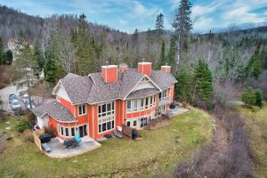 an aerial view of a large orange house at Rabaska by Rendez-Vous Mont-Tremblant in Mont-Tremblant