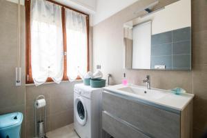 a bathroom with a washing machine and a sink at IL MANDORLO Apartment in Recco +42 photos