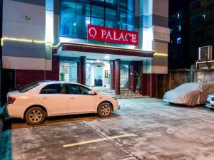 a white car parked in a parking lot in front of a palace at Q Palace in Comilla