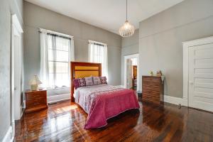 sypialnia z łóżkiem oraz drewnianą podłogą i oknami w obiekcie Bright Macon Home with Wraparound Deck! w mieście Macon
