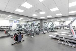 a gym with a lot of treadmills and machines at Midtown W 1BR w Gym Doorman nr Times Sq NYC-692 in New York