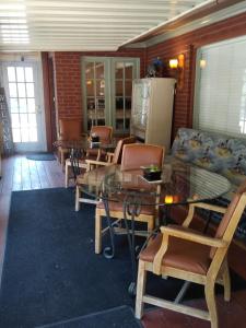 a room with chairs and a glass table and a couch at The Charin Inn in Clearfield