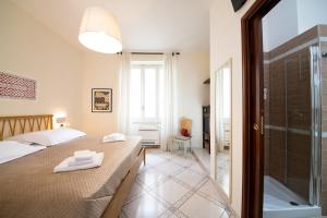 a bedroom with a bed and a glass shower at B&B Marcantonio - Ischia Ponte in Ischia