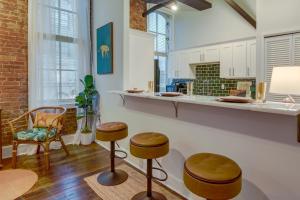 a kitchen with a counter and stools in a room at Historic Memphis Condo Walk to Beale Street! in Memphis