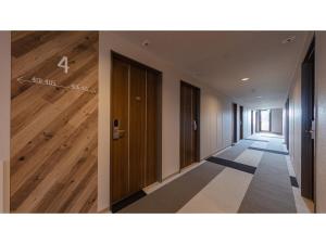 an empty hallway with wood flooring and a hallway with doors at Matto Terminal Hotel - Vacation STAY 98885v in Hakusan +8 photos