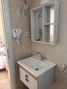 a bathroom with a sink and a mirror at Siwar Al-Thahab Suites & Hotel Apartments in Aqaba