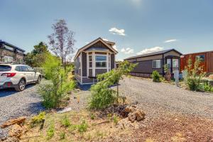 a house with a car parked in front of it at 2 Mi to Rainbow Lake Lovely Lakeside Tiny Home in Lake of the Woods