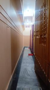 un pasillo con puertas de madera y un pasillo con un pasillo con un pasillo con un pasillo con un pasillo con un pasillo con una puerta de madera en Sushamalay Guest House At Sea Beach, Puri, en Puri