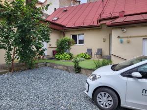 a white car parked in front of a house at Hope in Cluj-Napoca