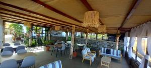 a restaurant with chairs and tables and a chandelier at Pipi's Guest House in São Filipe