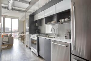 a kitchen with a sink and a refrigerator at NoMa studio w gym pet grooming nr metro WDC-701 in Washington