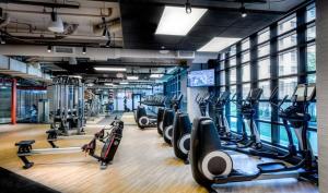a gym with rows of treadmills and cardio machines at NoMa studio w gym pet grooming nr metro WDC-701 in Washington