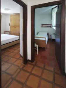 a room with two beds and a mirror at Casa Pineta in Procchio