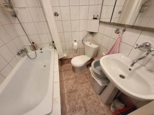 y baño con aseo, bañera y lavamanos. en Zabytkowa Kamienica, en Gdansk