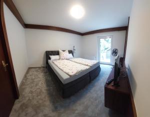 a bedroom with a bed and a television in it at Ferienwohnung Familie Cischeck in Gauting