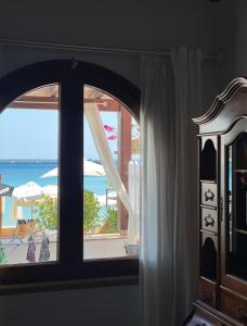 a room with a window with a view of the ocean at Beachfront House Pythagorion in Pythagoreio