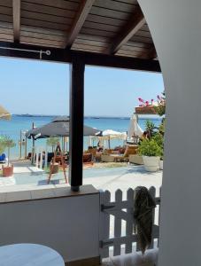 a view of the beach from the balcony of a resort at Beachfront House Pythagorion in Pythagoreio