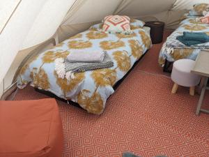 a room with two beds in a tent at Belle tent 2 in Wrexham