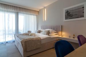 a bedroom with a large bed and a large window at Villa Valentina in Makarska