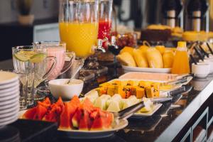 a buffet with plates of food and fruit on a counter at Espaço Paraíso Ortigueira in Ortigueira