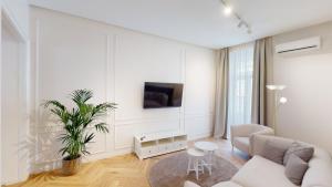 a white living room with a couch and a table at MATE in Rijeka