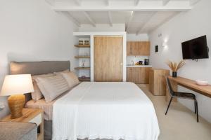 派萊卡斯的住宿－Casa Sabbia 10m from the beach，一间卧室配有一张床、一张沙发和一张桌子