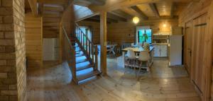 a room with a staircase in a wooden house at Biesówka in Wetlina