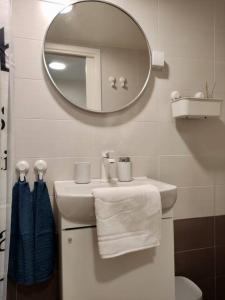 a bathroom with a white sink and a mirror at Studio Nina in Umag