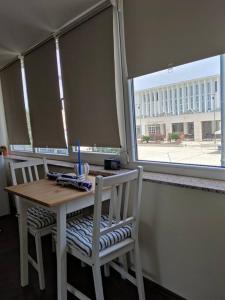 a table and two chairs with a table and a window at Studio Nina in Umag