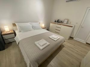 a bedroom with a large bed with two towels on it at Guest House Stojanoski in Ohrid