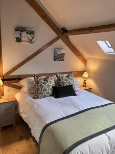 a bedroom with a large white bed with pillows at The Garret in Salisbury