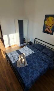 a bedroom with a bed with a blue comforter at Amar 2 in Zemun