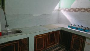 a kitchen with a sink and a counter top at Summer and winter homestay Turtuk Youl in Turtok