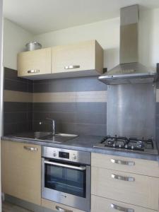 a kitchen with a stove and a sink at Appartement face Mer, idéal famille 6NOUM12 sea view 2 bedrooms apartment in Canet-en-Roussillon