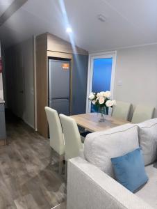 a living room with a table and a couch at Brand New Modern Holiday Home - Haven The Orchards Holiday Park in Saint Osyth