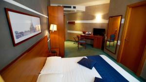 A bed or beds in a room at Classic Hotel Tulipano