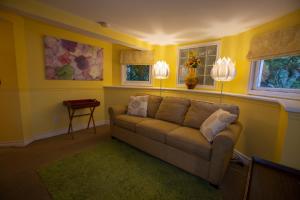 a living room with a couch and two lamps at Barclay House Bed and Breakfast in Vancouver