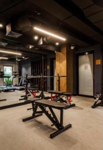 a gym with a row of tread machines in a room at Motlawa Inn Apartment-Suna,Gym&Parking in Gdańsk