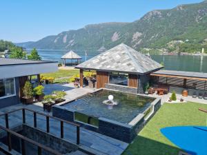 an aerial view of a house with a pond at Bremanger Fjord Hotell in Svelgen