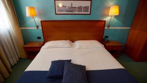 A bed or beds in a room at Classic Hotel Tulipano