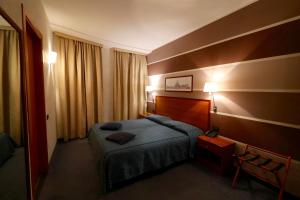 A bed or beds in a room at Classic Hotel Tulipano