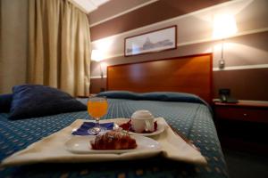 A bed or beds in a room at Classic Hotel Tulipano