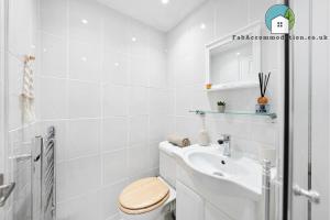 a white bathroom with a toilet and a sink at Central Apt-2Bed 2Bath-AC unit-By FabAccommodation in Bristol