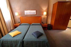 A bed or beds in a room at Classic Hotel Tulipano